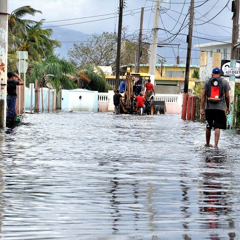 People walking through flooded streets in Puerto Rico.