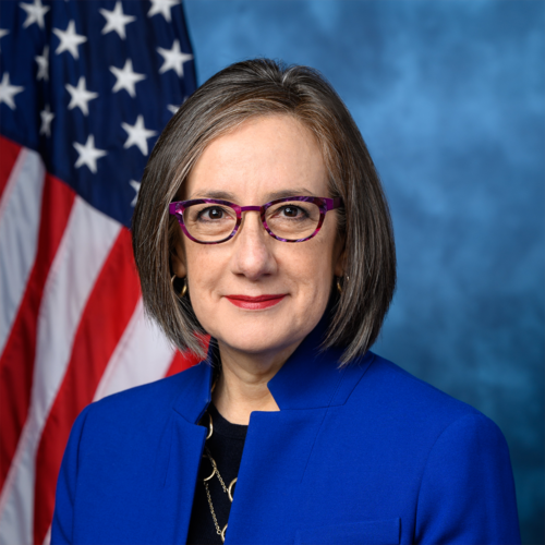 Portrait of Representative Andrea Salinas in front of an American flag