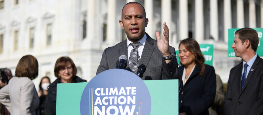 Senator Hakeem Jeffries speaking at a podium during a Climate Action Now event.
