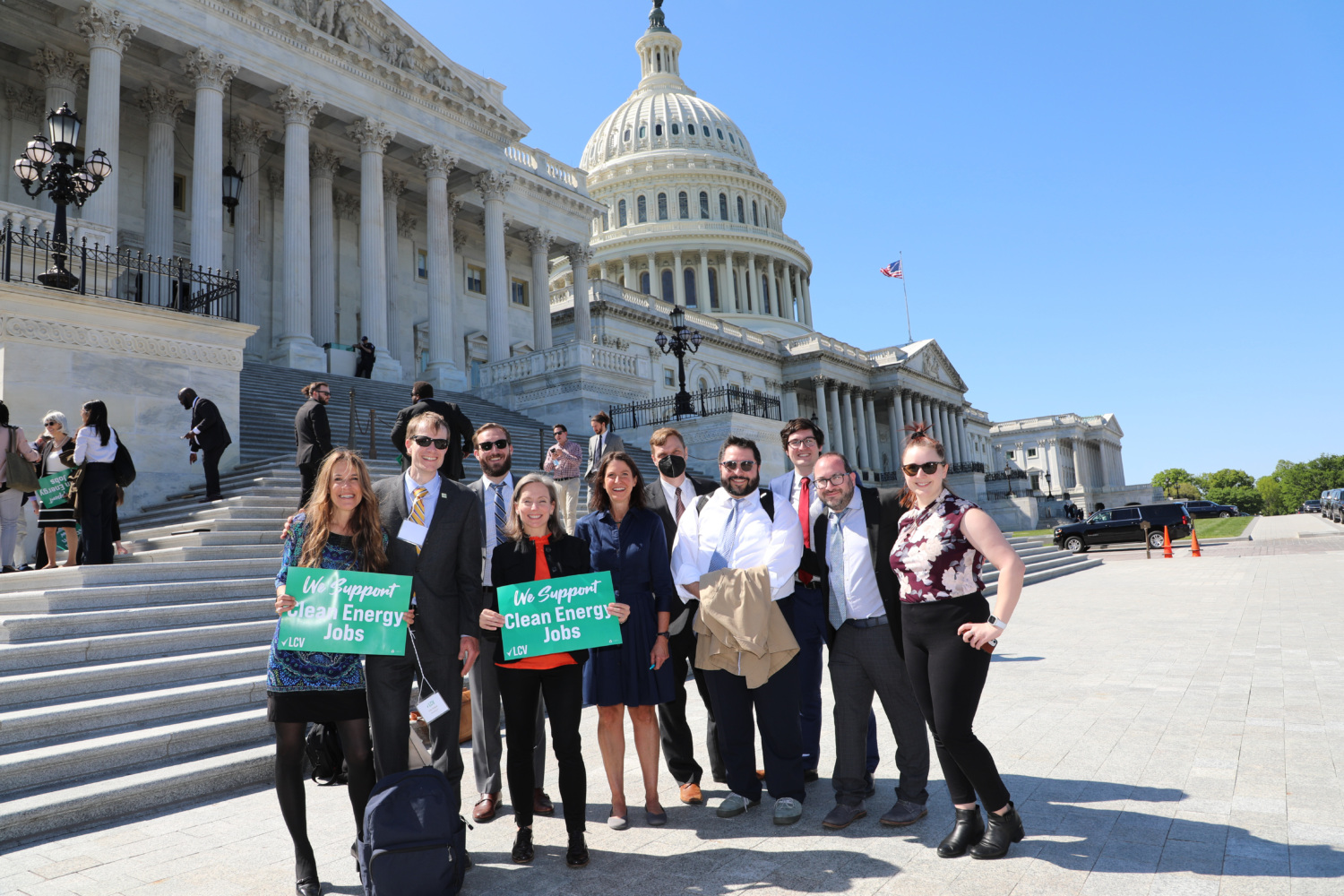 LCV staff pose with "Climate Action Now" and "We Support Clean Energy Jobs" signs in front of Capitol building in DC