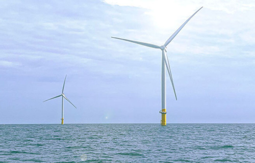 Two offshore wind turbines.