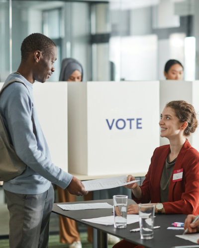 A man checks in to vote at a polling station.