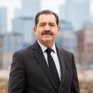 Portrait of Representative Chuy García against a backdrop of the Chicago skyline.