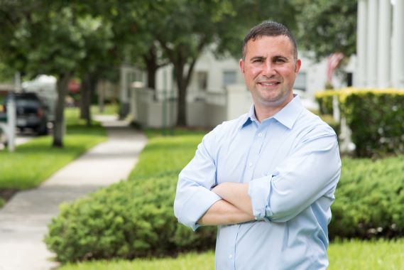Portrait of Representative Darren Soto standing in a neighborhood.