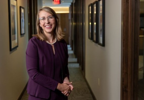 Portrait of Representative Hillary Scholten standing in a hallway.