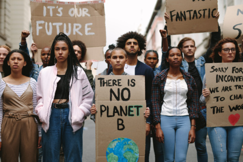 A group of defiant young protestors holding signs that read, "It's our future", "There is no Planet B".
