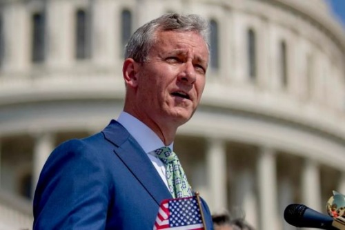 Representative Matt Cartwright speaks with the Capitol seen in the background.