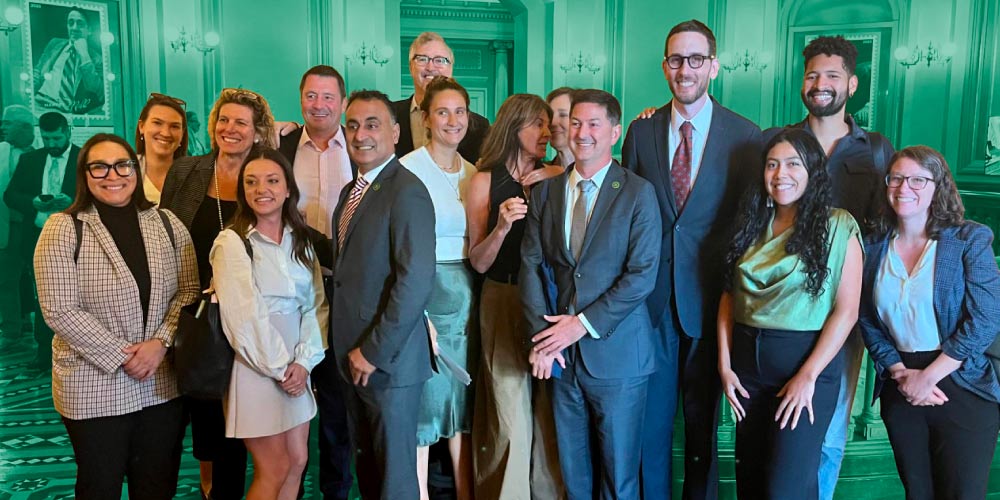 Staff from LCV’s CA state affiliate and CA state electeds pose for a photo after the passage of SB 253, which requires corporations to disclose emissions.