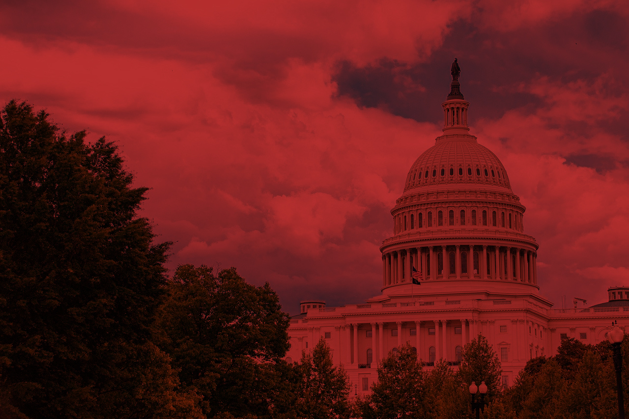 Capitol building in a cloudy skyline, tinted red