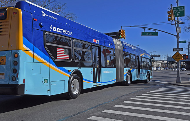 An electric bus driving in New York City.