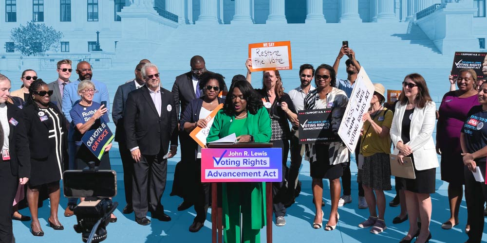 A group of electeds and partner organizations stands in front of the U.S. Supreme Court building for a press conference on the John R. Lewis Voting Rights Advancement Act