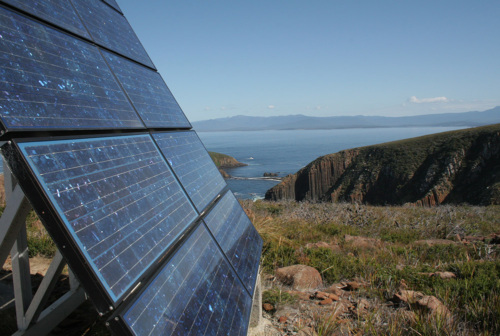 Closeup of solar panel in front of scenic overlook in Australia.