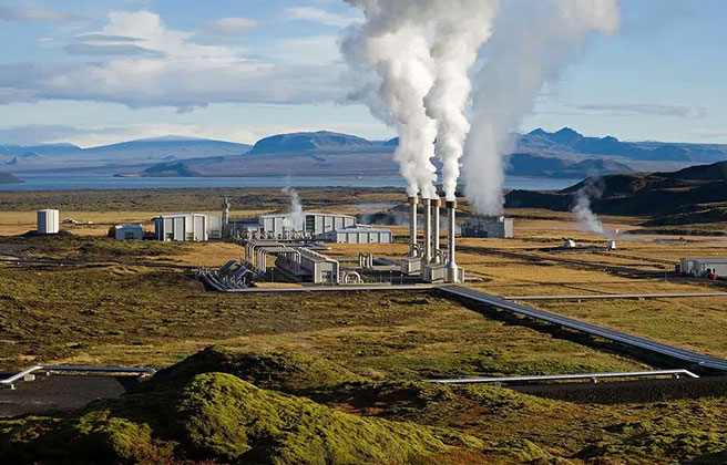 Landscape view of factory in Europe producing pollution smoke.