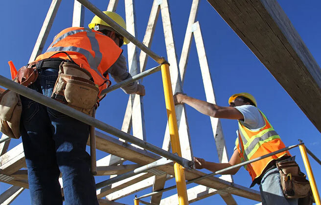 Construction workers on a scaffolding.