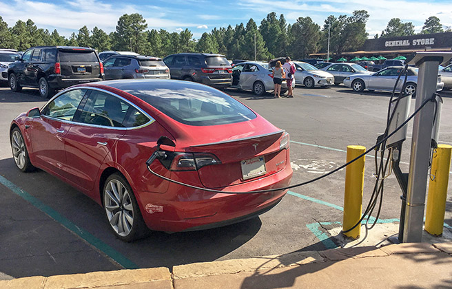 Electric vehicle charging in parking lot at Grand Canyon National Park.