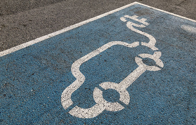 Closeup of a parking spot with symbol for electric vehicle.