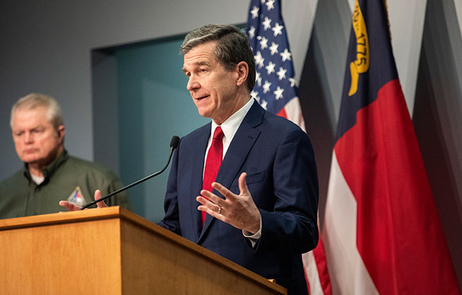 Governor Roy Cooper delivering a speech at a podium.