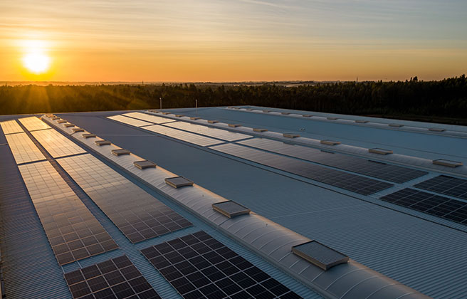 Rooftop solar in front of sunset.