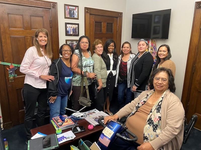 Group of women pose with Congresswoman Jasmine Crockett in her office