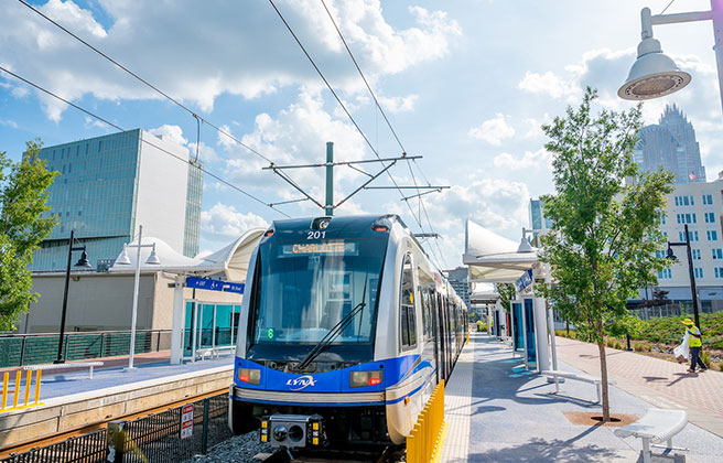 Light rail train travelling through urban area in Charlotte.