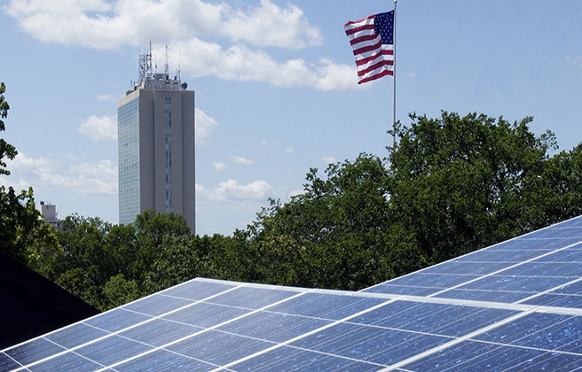 Solar panels in front of building and American flag in Michigan.