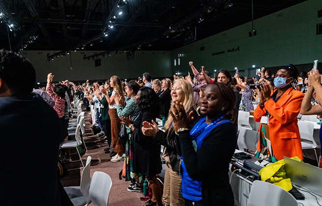 The audience for the COP28 meeting applauds.