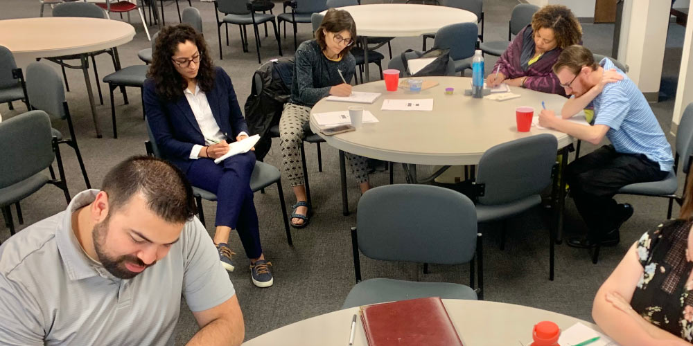 Participants at the LCVEF’s Boards and Commissions Fellowship program work around tables.