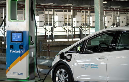 An electric vehicle plugged into a charging station.
