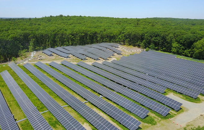 Massachusetts solar farm with many rows of panels.