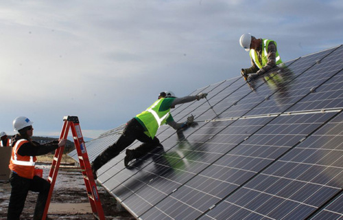 Solar workers installing panels.