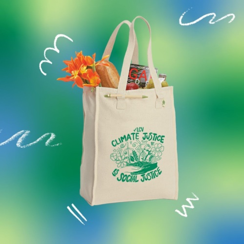 Cotton tote bag, with green screenprint design reading "Climate Justice is Social Justice," filled with groceries.
