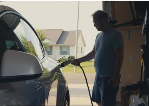 Chris plugging in his electric car in the garage
