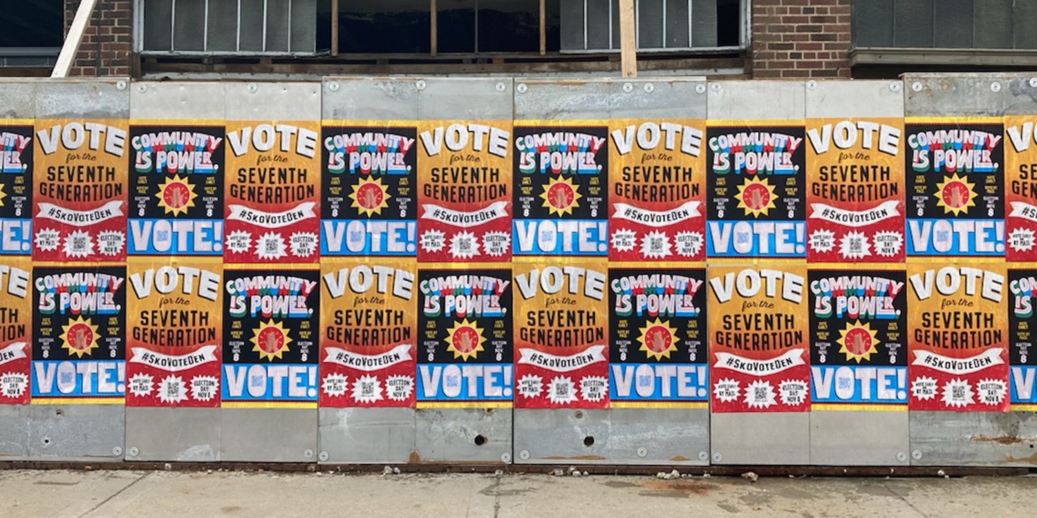 Wheatpaste signs in a neighborhood reading "vote" and "community is power."