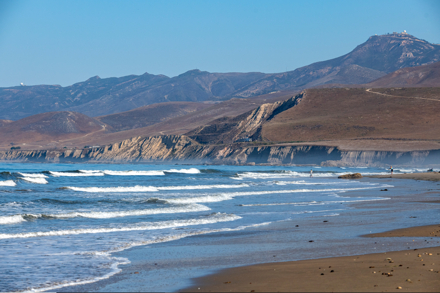 A beach and mountains.