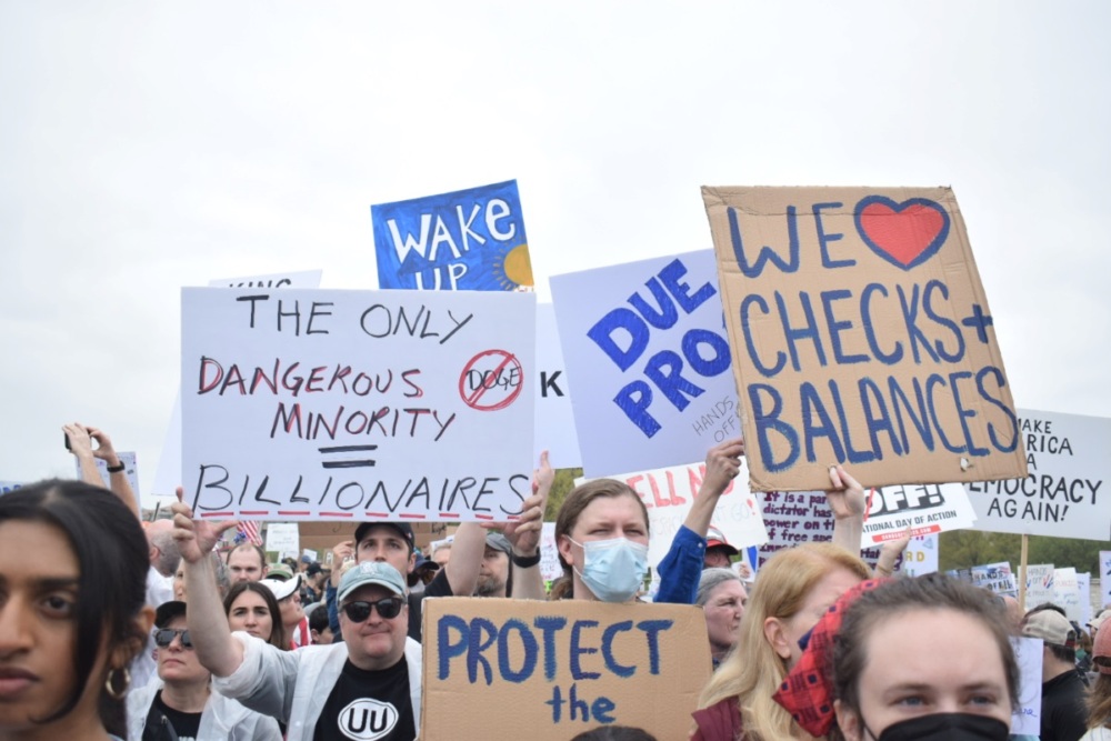 Signs protesting Donald Trump and Elon Musk.