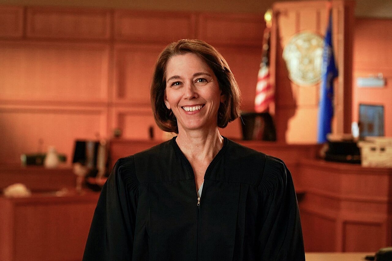 Judge Susan Crawford stands in a courtroom.