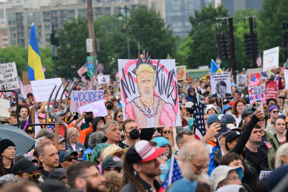 Protesters carrying signs march in Philadelphia.