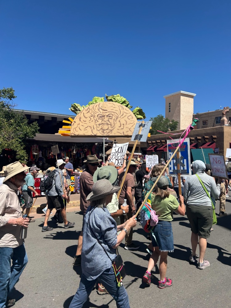 Protesters march in Santa Fe, New Mexico carrying a giant taco.