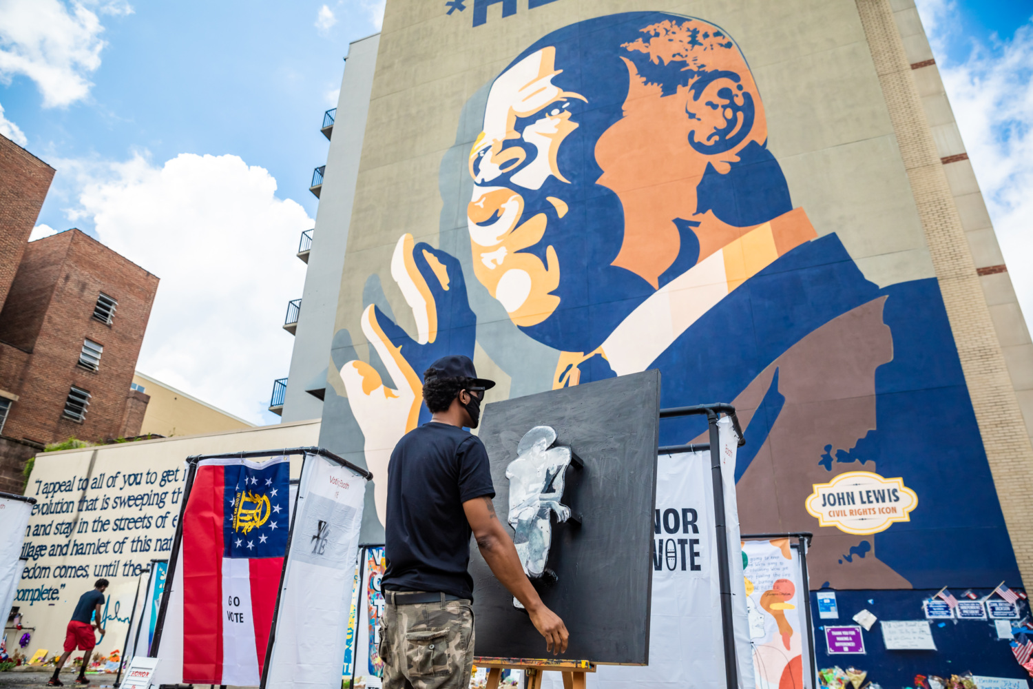 A mural of John Lewis on the side of a building.