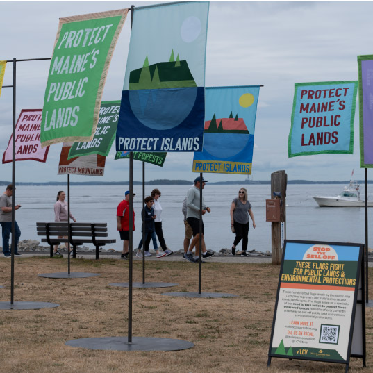 Flags calling for public lands protections wave in the wind in Maine