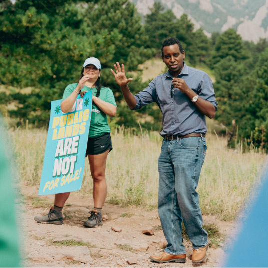 Congressman Joe Neguse speaks to hikers in Boulder Colorado