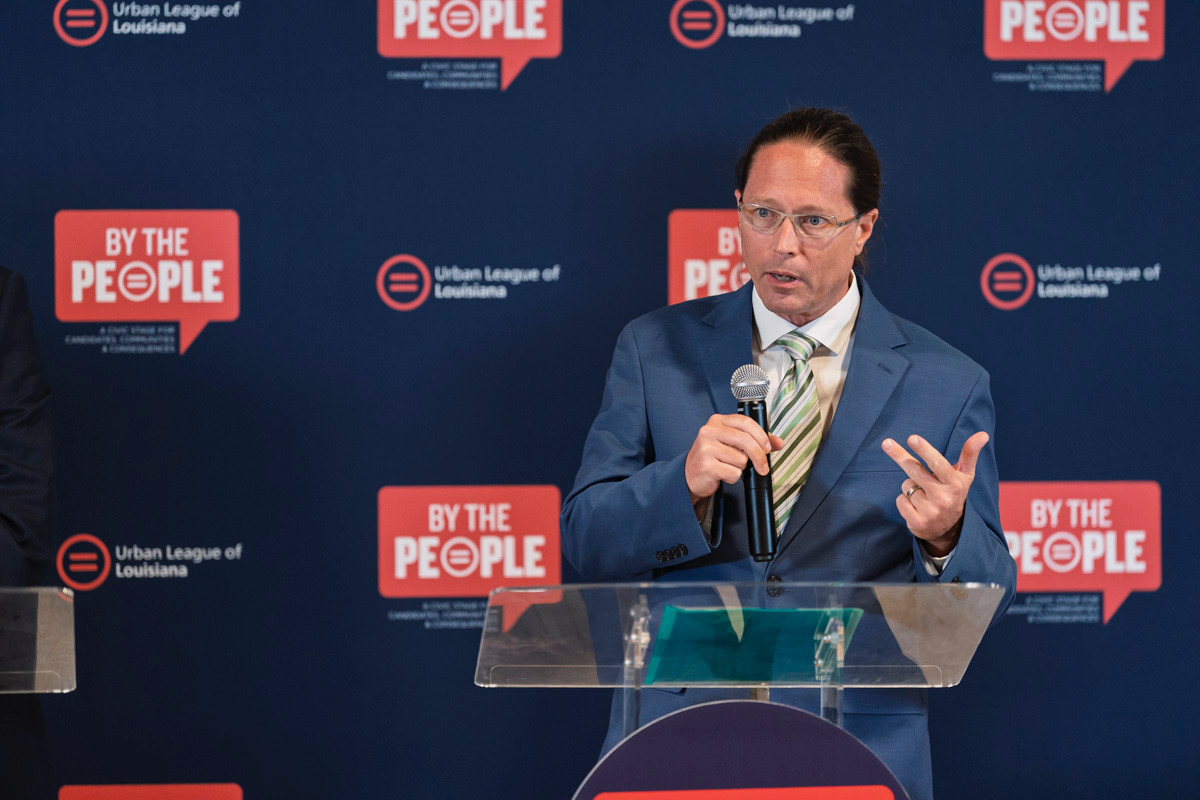 A man speaks at a podium during a campaign event.