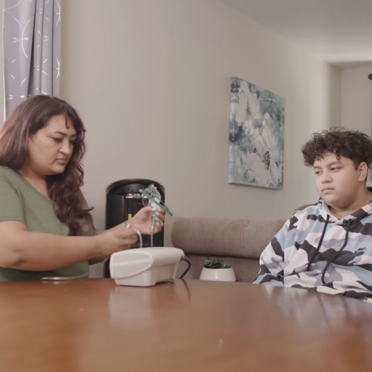 Ana Loaiza-Campean sets up the breathing machine for her son