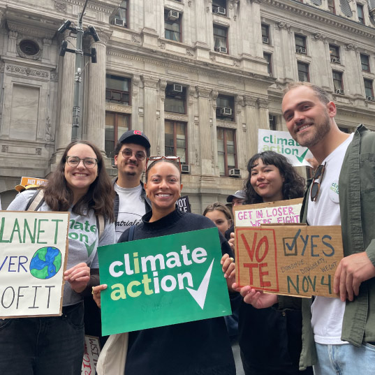 Climate Action activists hold signs at a march