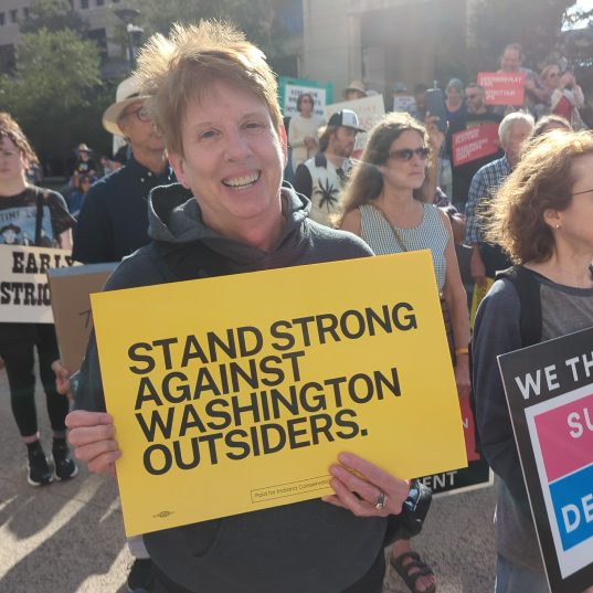 Indiana residents gathered with signs denouncing the redistricting efforts by Washington outsiders