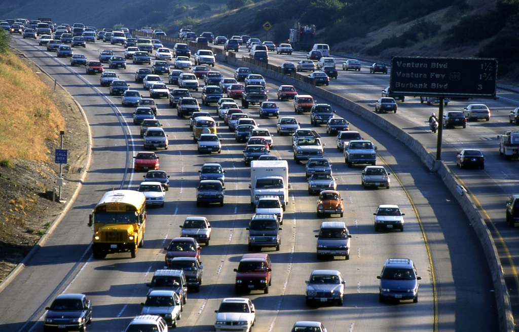 Cars drive on a busy highway.
